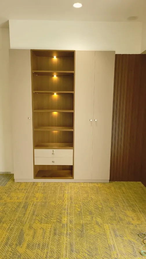 Installed wardrobe with lit open shelves